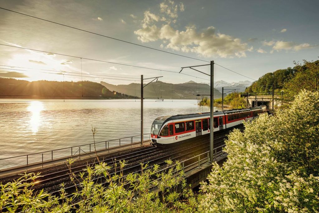 Swiss train passing a lake