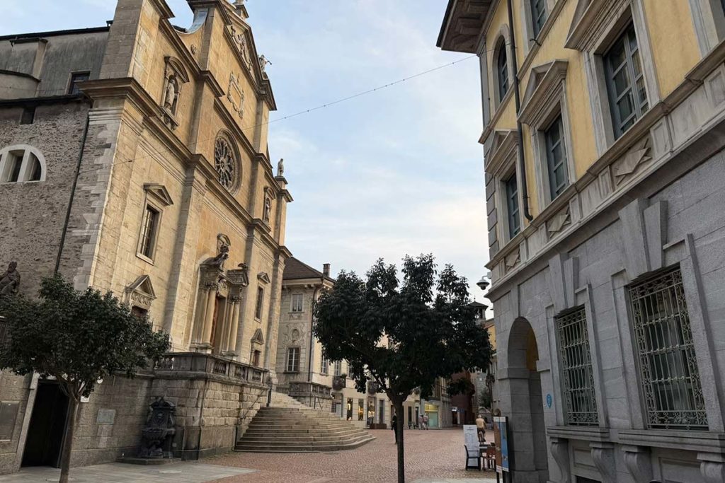 Historic church and surrounding buildings in Bellinzona's old town square